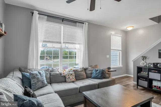 a view of a white house in front of yard