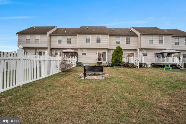 a view of a house with a yard and sitting area