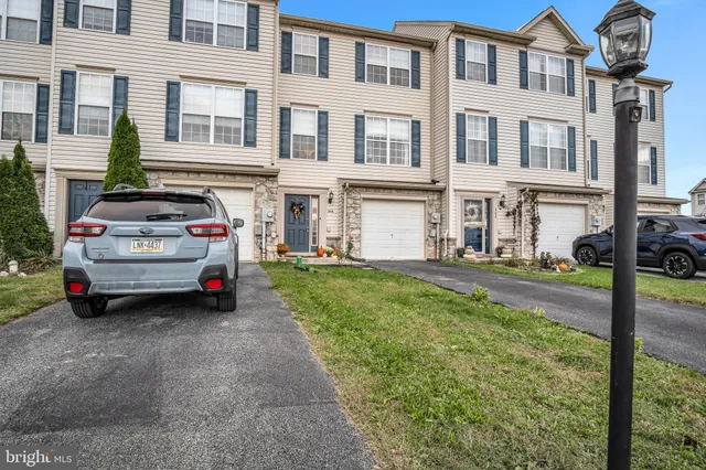 a view of a patio with a table and chairs under an umbrella