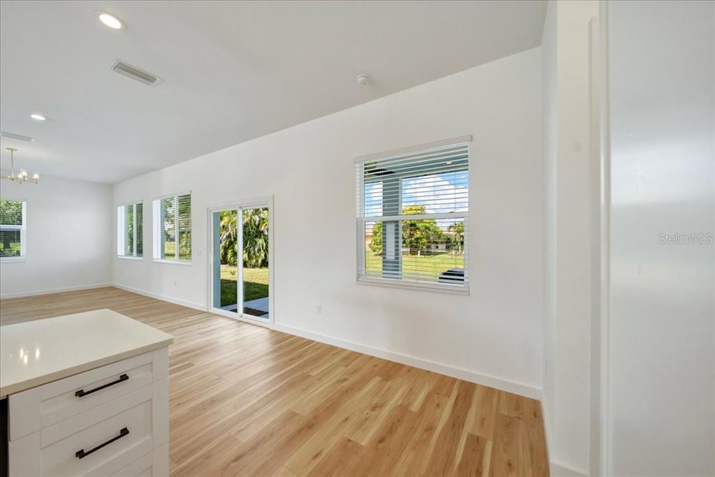 1215 Rio De Janeiro Avenue Punta Gorda, FL 33983 - Photo 17 of 65 a view of an empty room with window and wooden floor