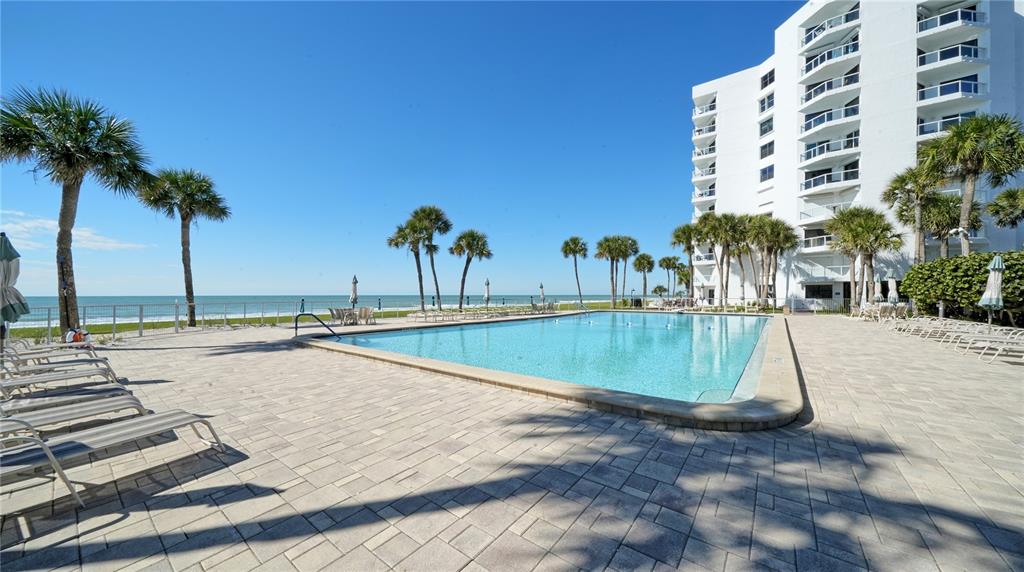 1000 Longboat Club Road, Unit 304 Longboat Key, FL 34228 - Photo 6 of 17 a view of swimming pool with outdoor seating and palm trees