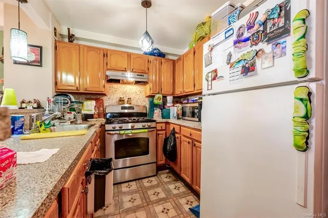 a kitchen with stainless steel appliances granite countertop a sink and a stove