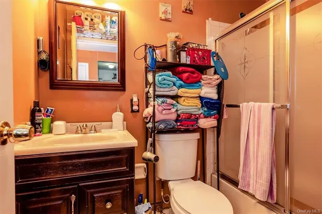 a bathroom with a sink a toilet and curtain