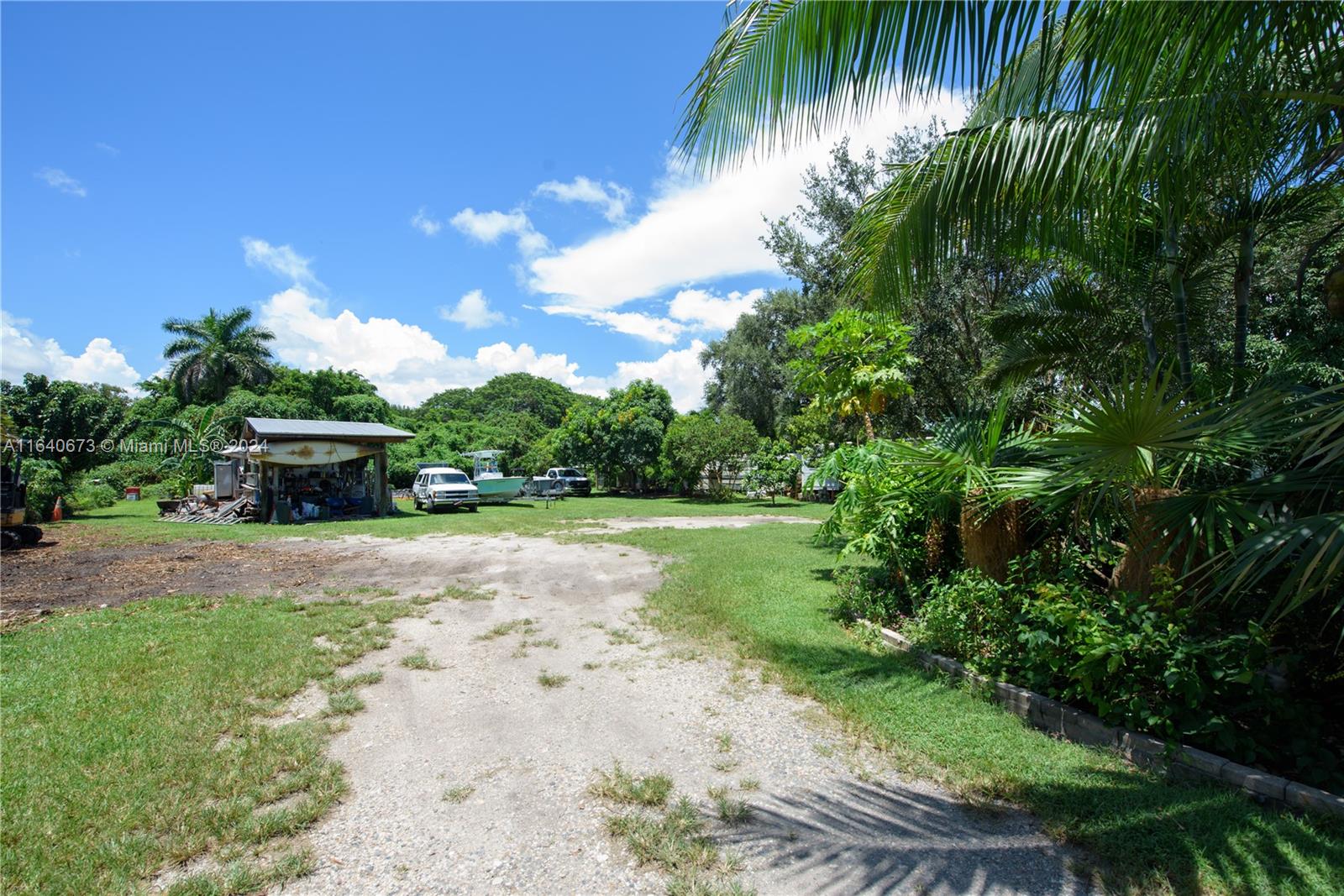 29744 Southwest 170th Avenue Homestead, FL 33030 - Photo 13 of 44 a backyard of a house with lots of green space