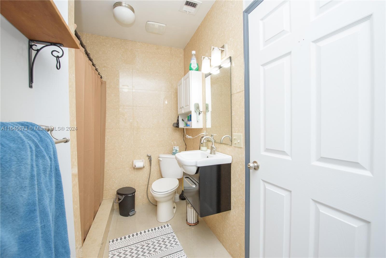 29744 Southwest 170th Avenue Homestead, FL 33030 - Photo 22 of 44 a bathroom with a sink a toilet and shower curtain
