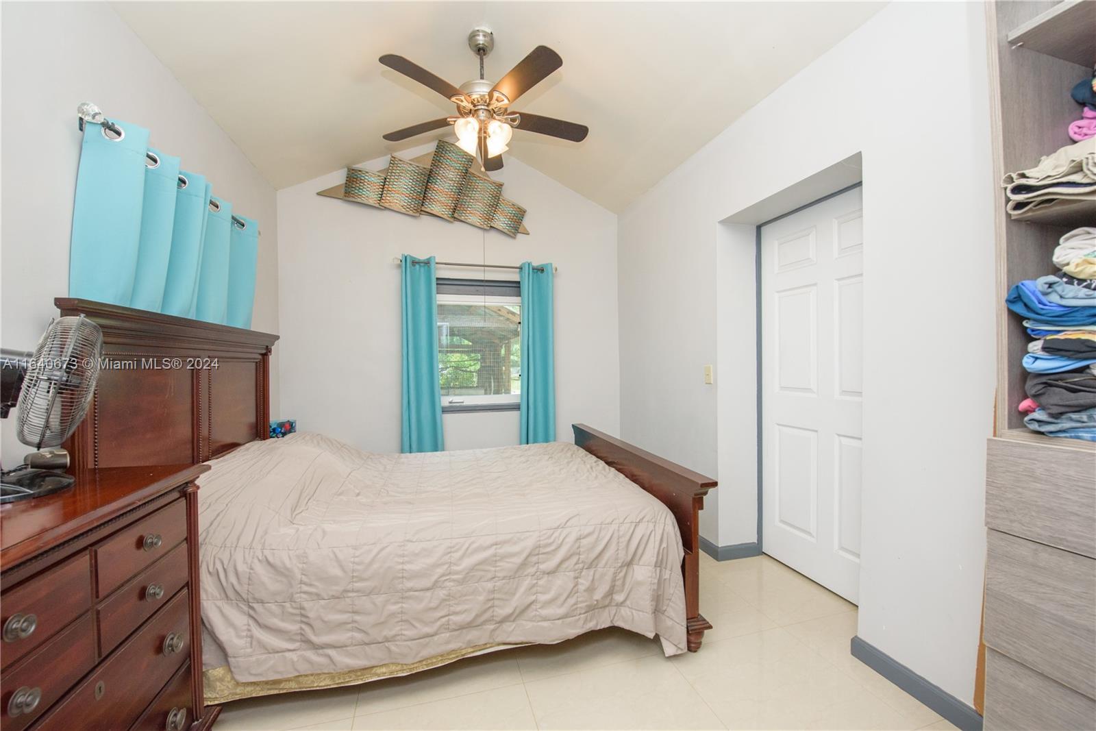 29744 Southwest 170th Avenue Homestead, FL 33030 - Photo 23 of 44 a bedroom with a bed dresser and a window