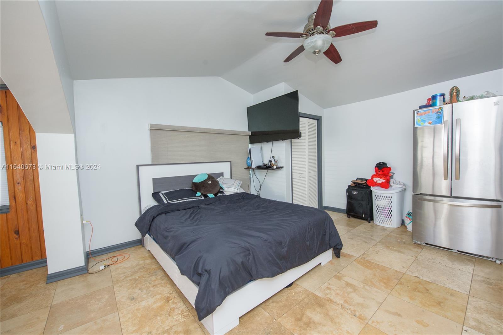 29744 Southwest 170th Avenue Homestead, FL 33030 - Photo 24 of 44 a bedroom with a bed and a refrigerator