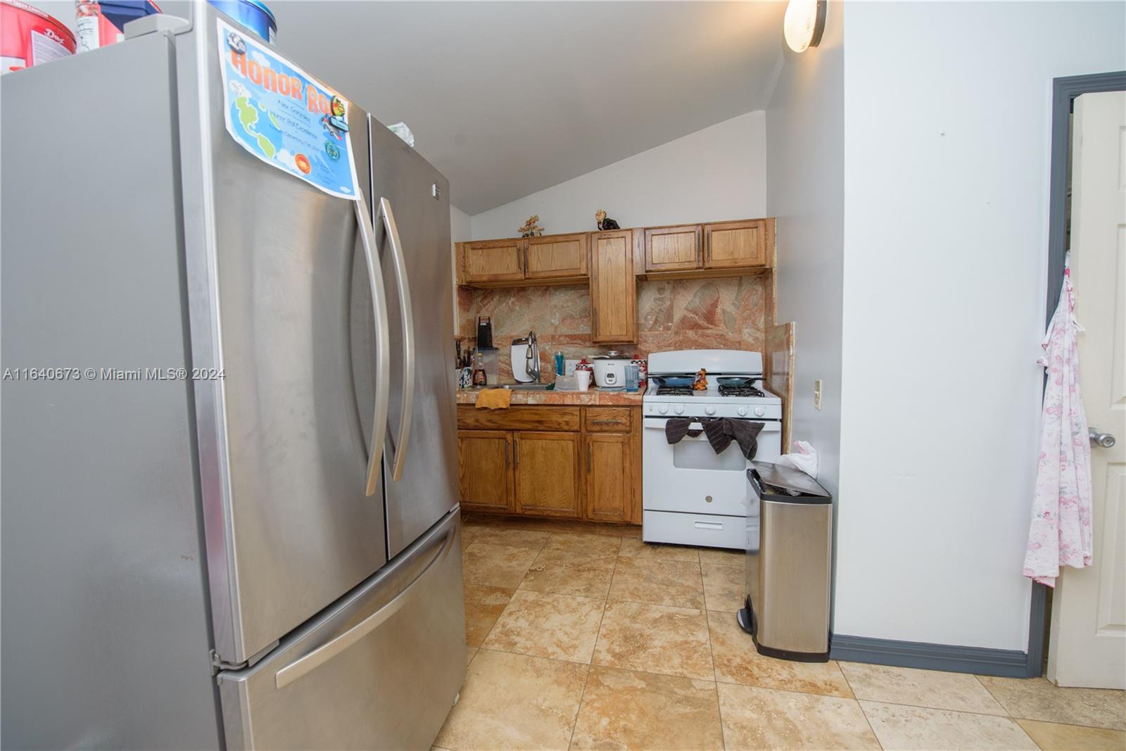 29744 Southwest 170th Avenue Homestead, FL 33030 - Photo 26 of 44 a kitchen with a refrigerator and a stove