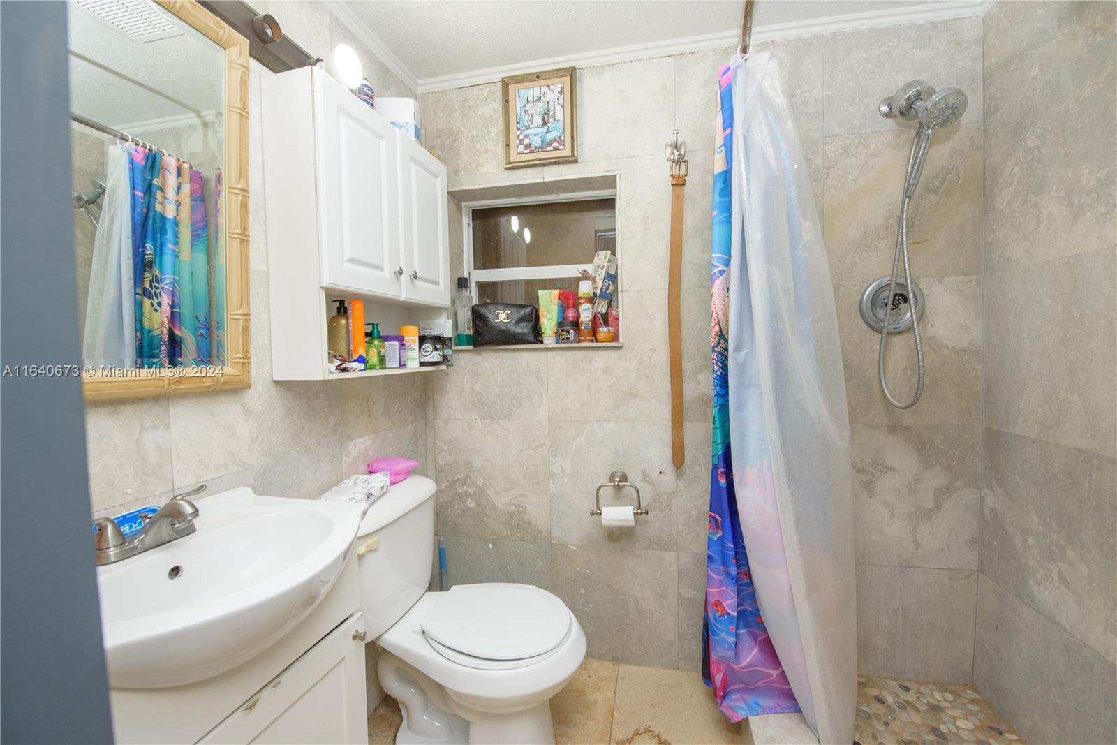 29744 Southwest 170th Avenue Homestead, FL 33030 - Photo 27 of 44 a white toilet sitting next to a bathroom sink