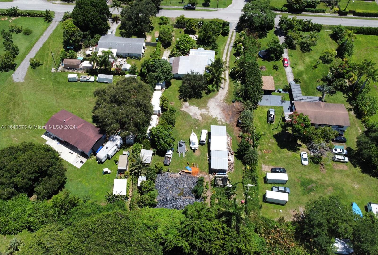 29744 Southwest 170th Avenue Homestead, FL 33030 - Photo 34 of 44 an aerial view of residential houses with outdoor space and street view