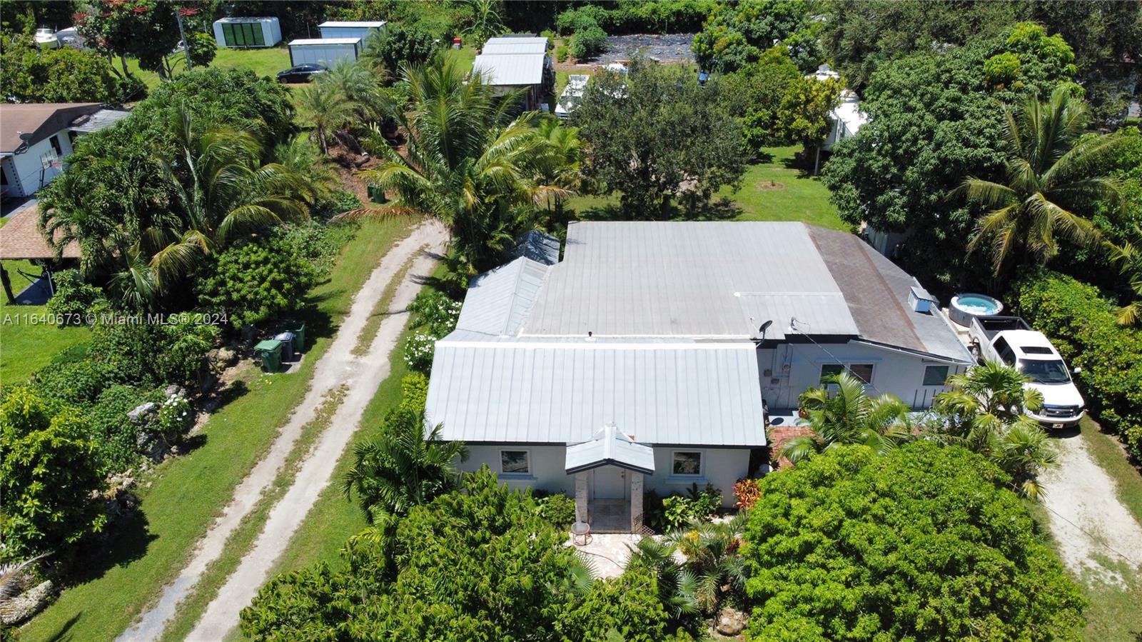 29744 Southwest 170th Avenue Homestead, FL 33030 - Photo 40 of 44 an aerial view of a house with a yard and trees all around