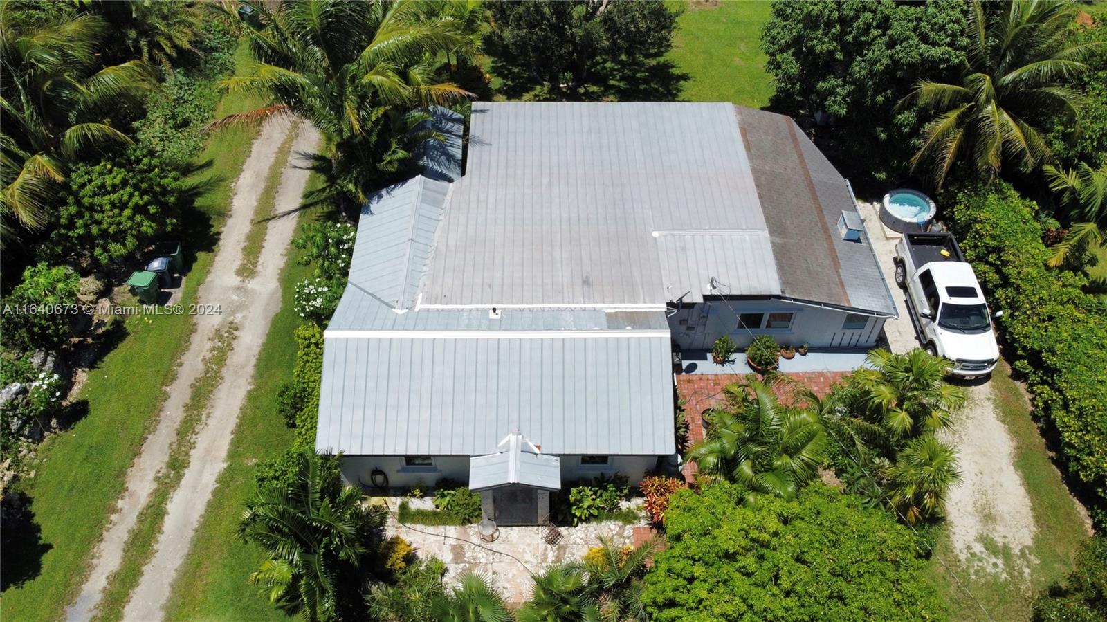 29744 Southwest 170th Avenue Homestead, FL 33030 - Photo 43 of 44 an aerial view of a house with a garden and trees