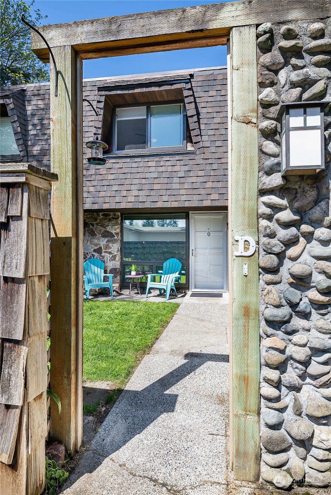 20620 76th Avenue West, Unit D Edmonds, WA 98026 - Photo 2 of 30 a view of a house with a small garden and plants