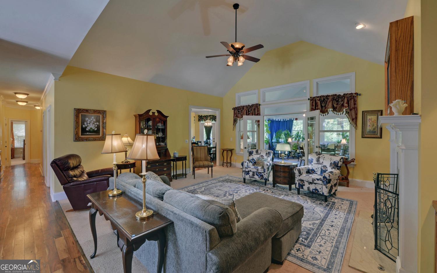 227 Capri Drive Hartwell, GA 30643 - Photo 15 of 75 a living room with lots of furniture and a chandelier