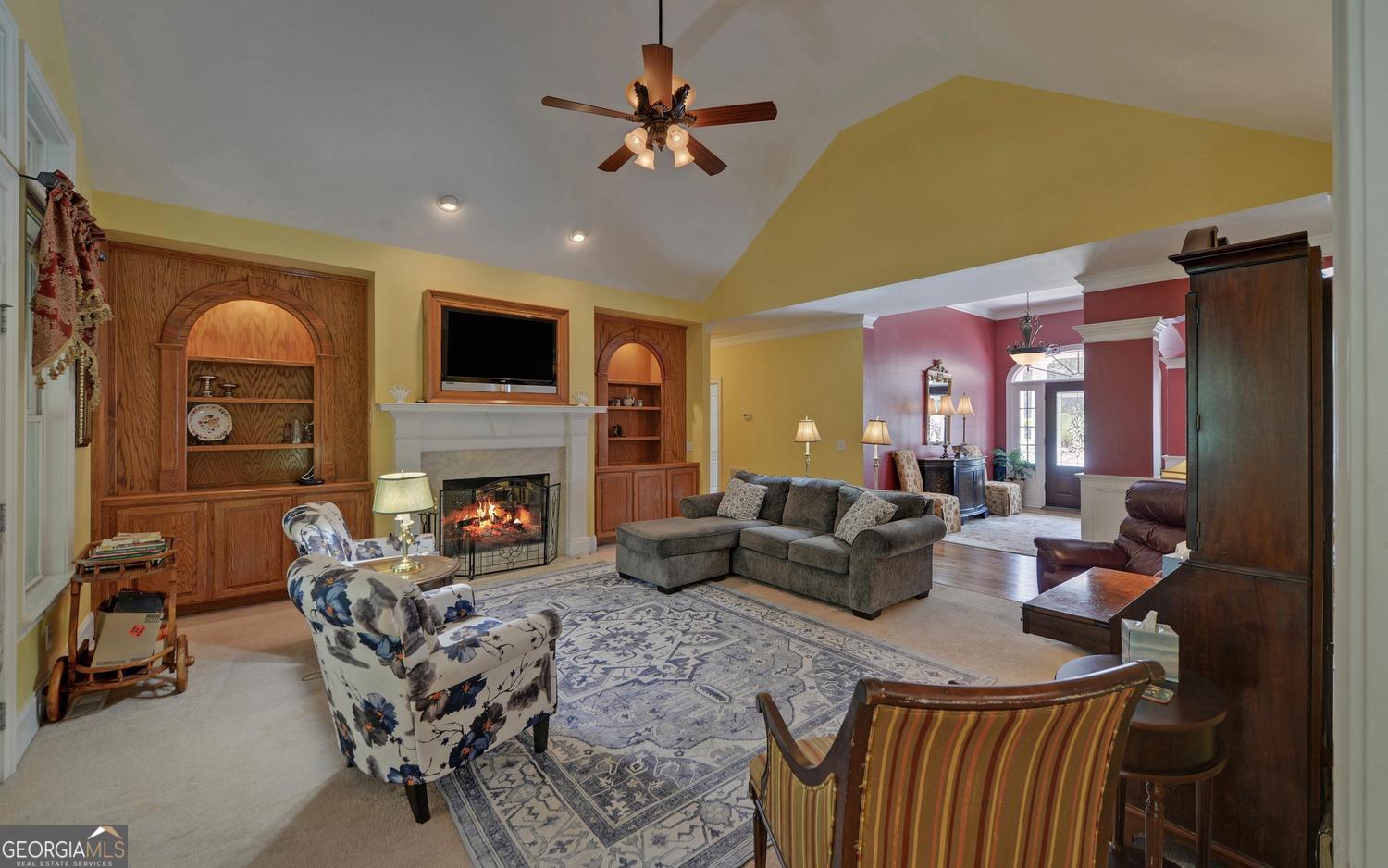 227 Capri Drive Hartwell, GA 30643 - Photo 17 of 75 a living room with furniture a fireplace and a flat screen tv