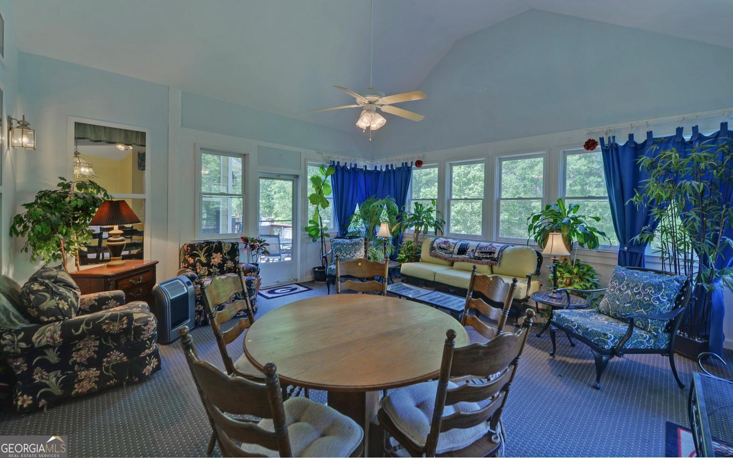 227 Capri Drive Hartwell, GA 30643 - Photo 19 of 75 a living room with furniture a chandelier and a dining table