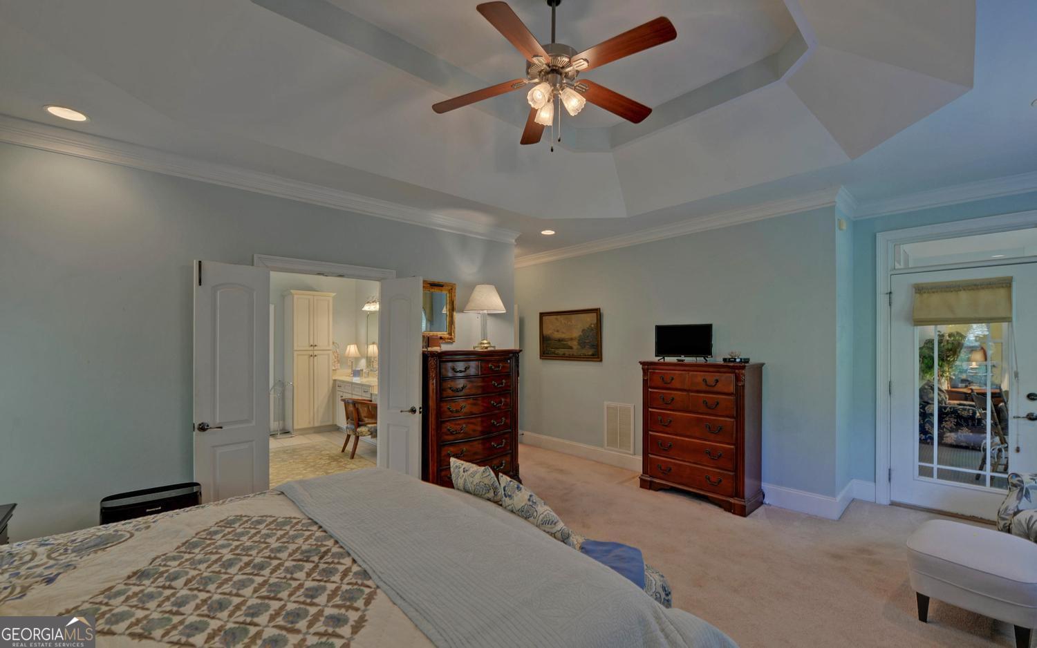 227 Capri Drive Hartwell, GA 30643 - Photo 24 of 75 a bedroom with a bed and a chandelier