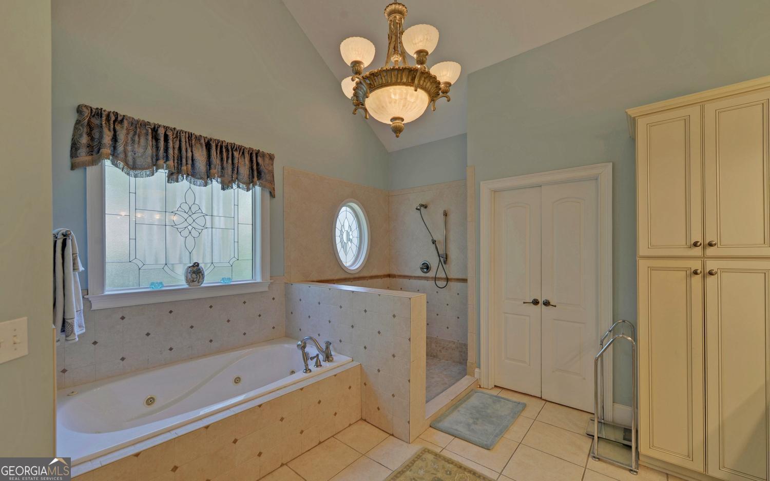 227 Capri Drive Hartwell, GA 30643 - Photo 26 of 75 a bathroom with a bathtub a sink and a mirror