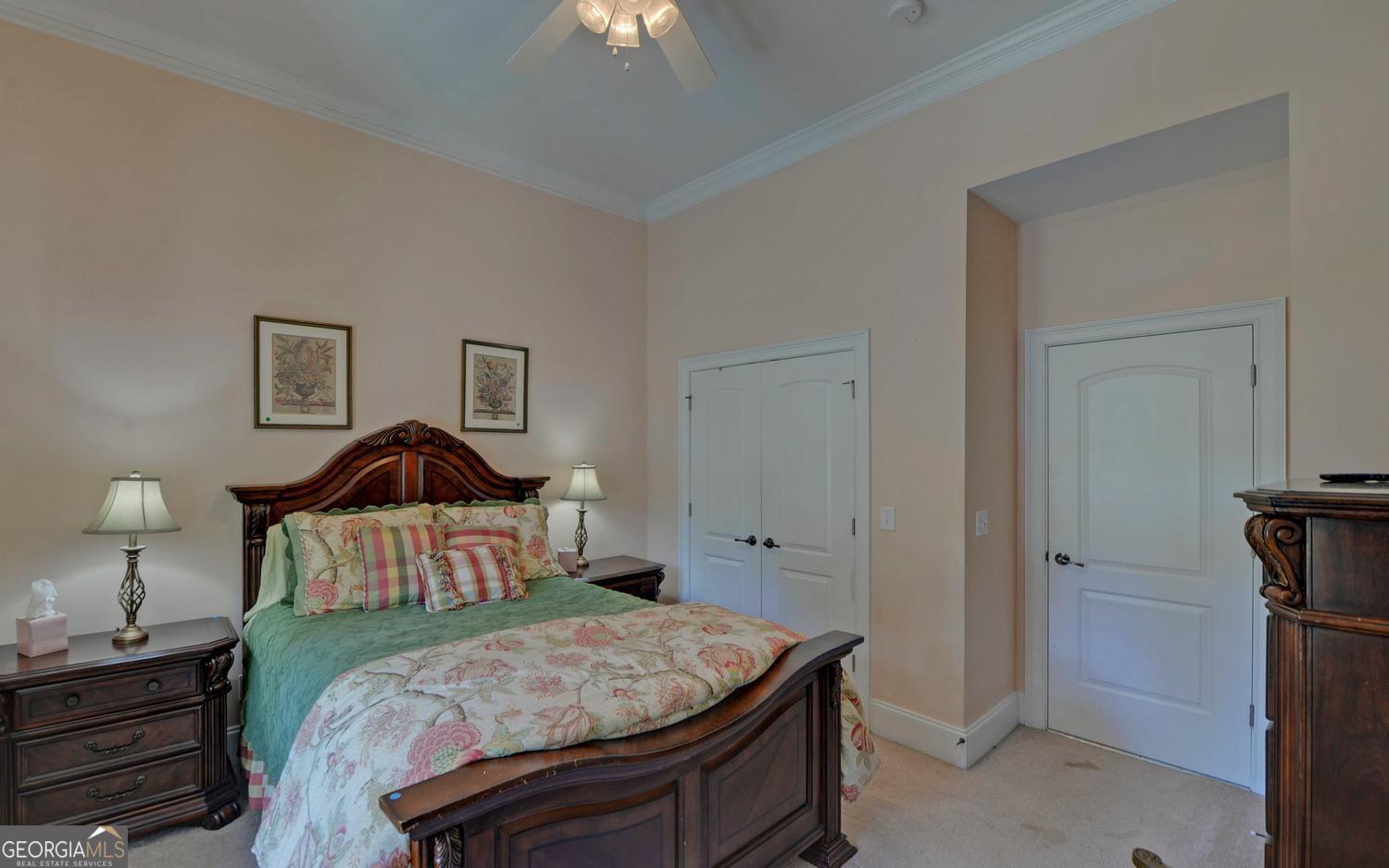 227 Capri Drive Hartwell, GA 30643 - Photo 32 of 75 a bedroom with a bed and a chandelier