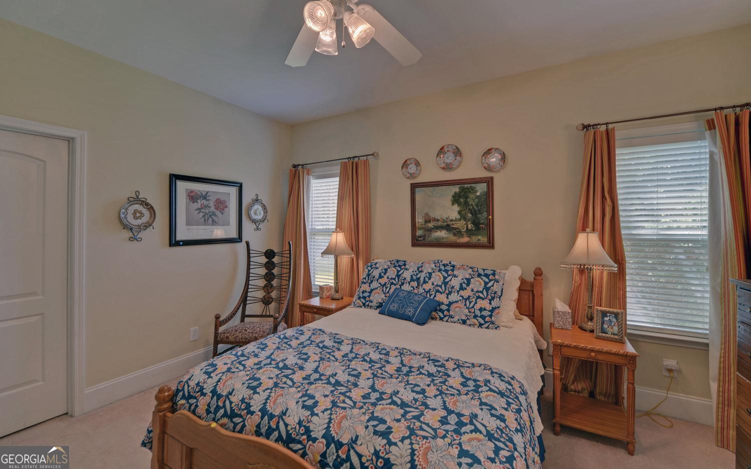 227 Capri Drive Hartwell, GA 30643 - Photo 34 of 75 a bedroom with a large bed and a chandelier