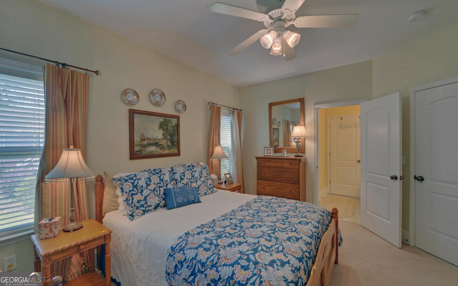227 Capri Drive Hartwell, GA 30643 - Photo 35 of 75 a bedroom with a bed and a chandelier