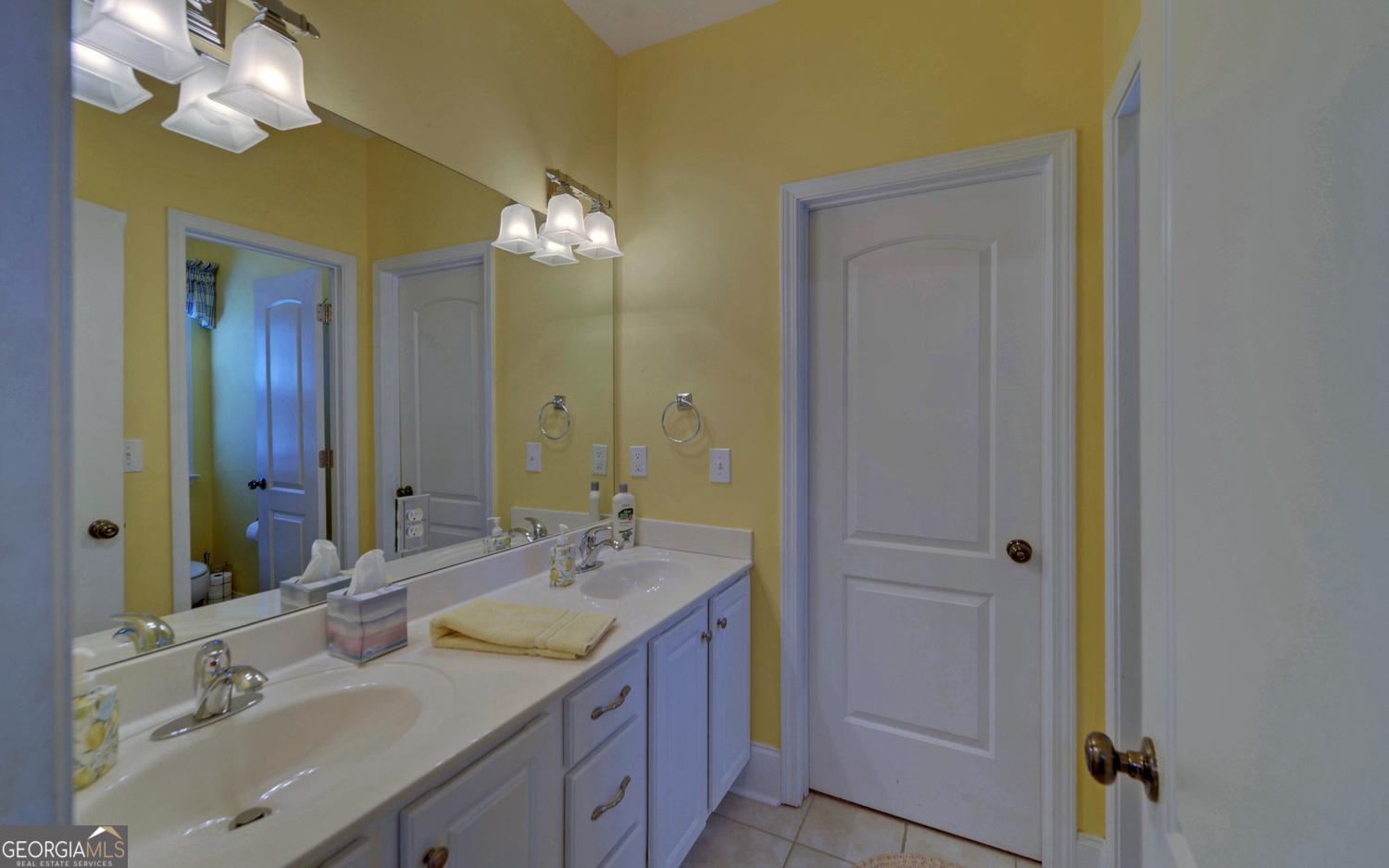 227 Capri Drive Hartwell, GA 30643 - Photo 38 of 75 a bathroom with a granite countertop sink and a mirror