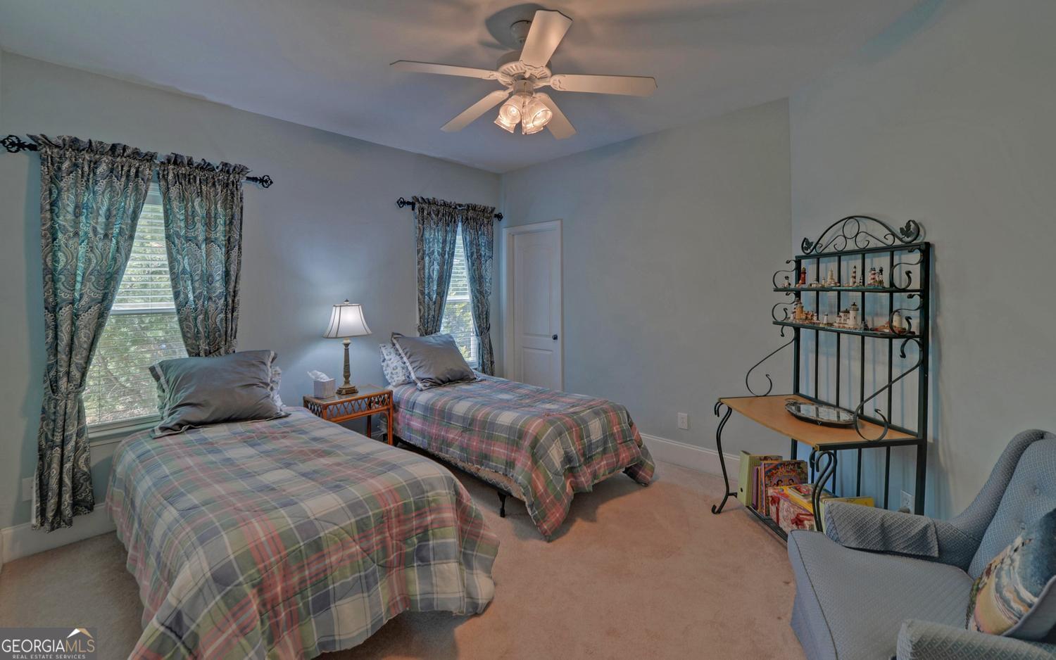 227 Capri Drive Hartwell, GA 30643 - Photo 39 of 75 a bedroom with two beds and a chandelier