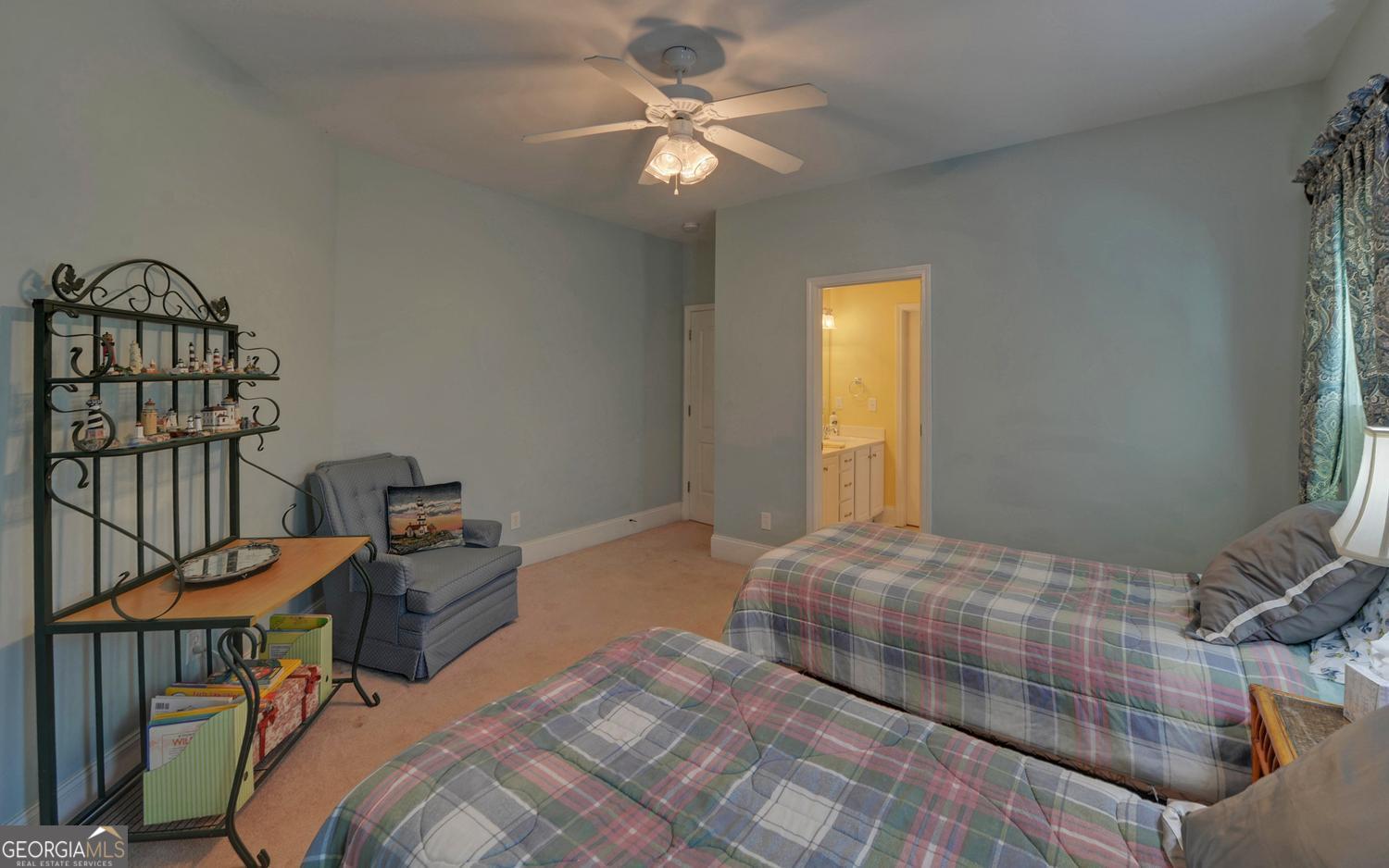 227 Capri Drive Hartwell, GA 30643 - Photo 40 of 75 a bedroom with a bed and a chandelier