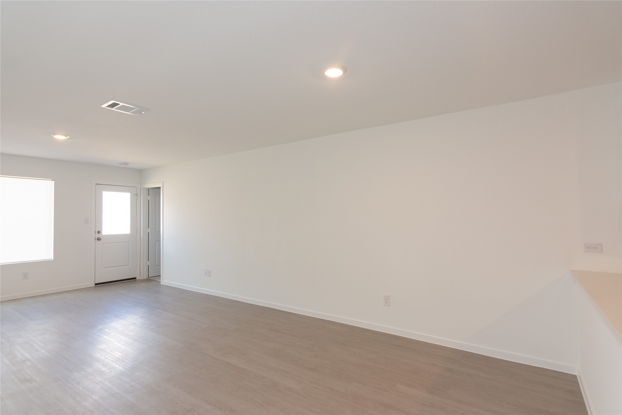 149 Star Packer Lane Jarrell, TX 76537 - Photo 8 of 30 Laminate flooring throughout this naturally illuminated, open-concept living space with recessed lighting.