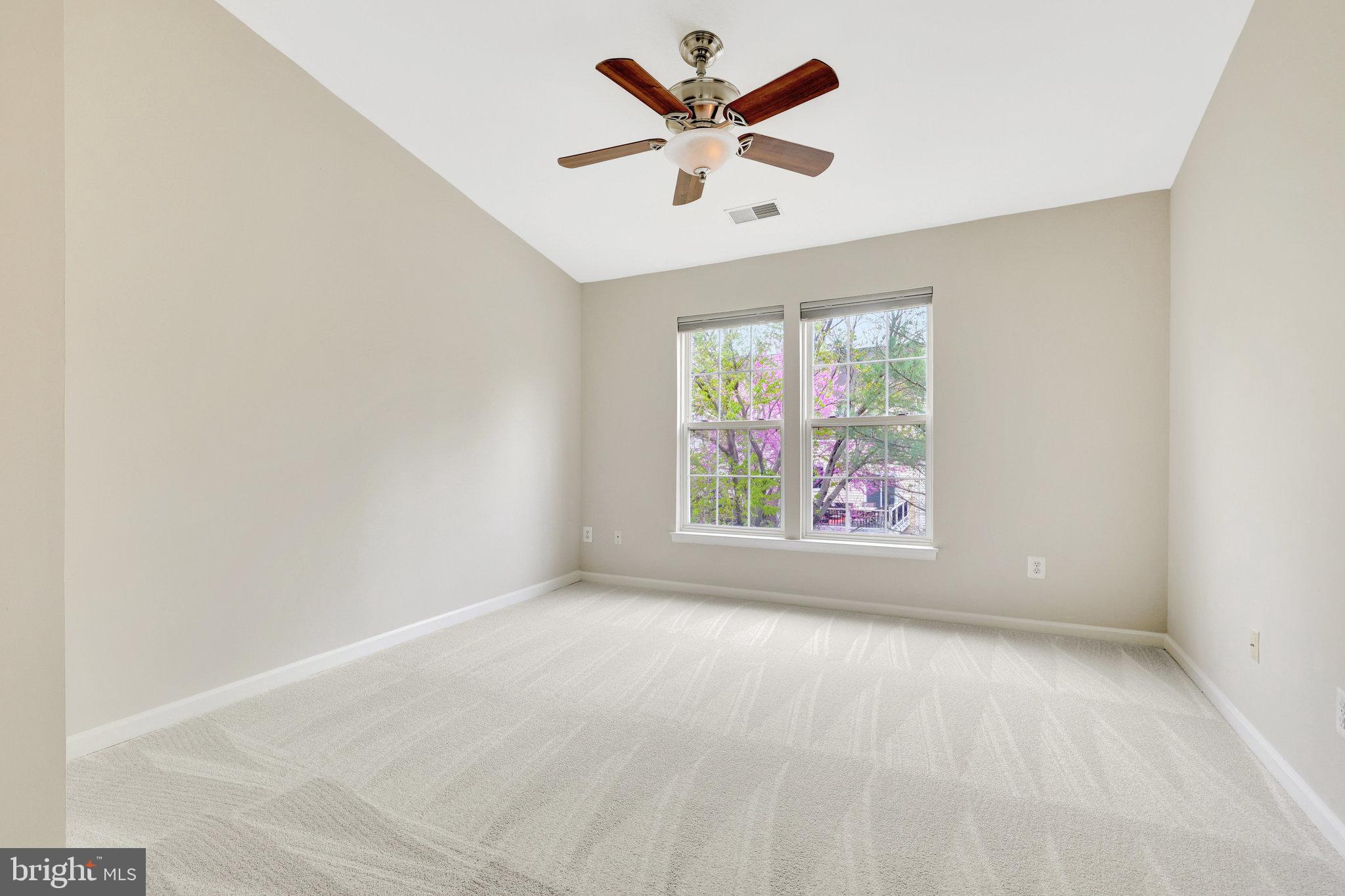 43233 Stillforest Terrace Ashburn, VA 20147 - Photo 14 of 24 an empty room with windows and fan