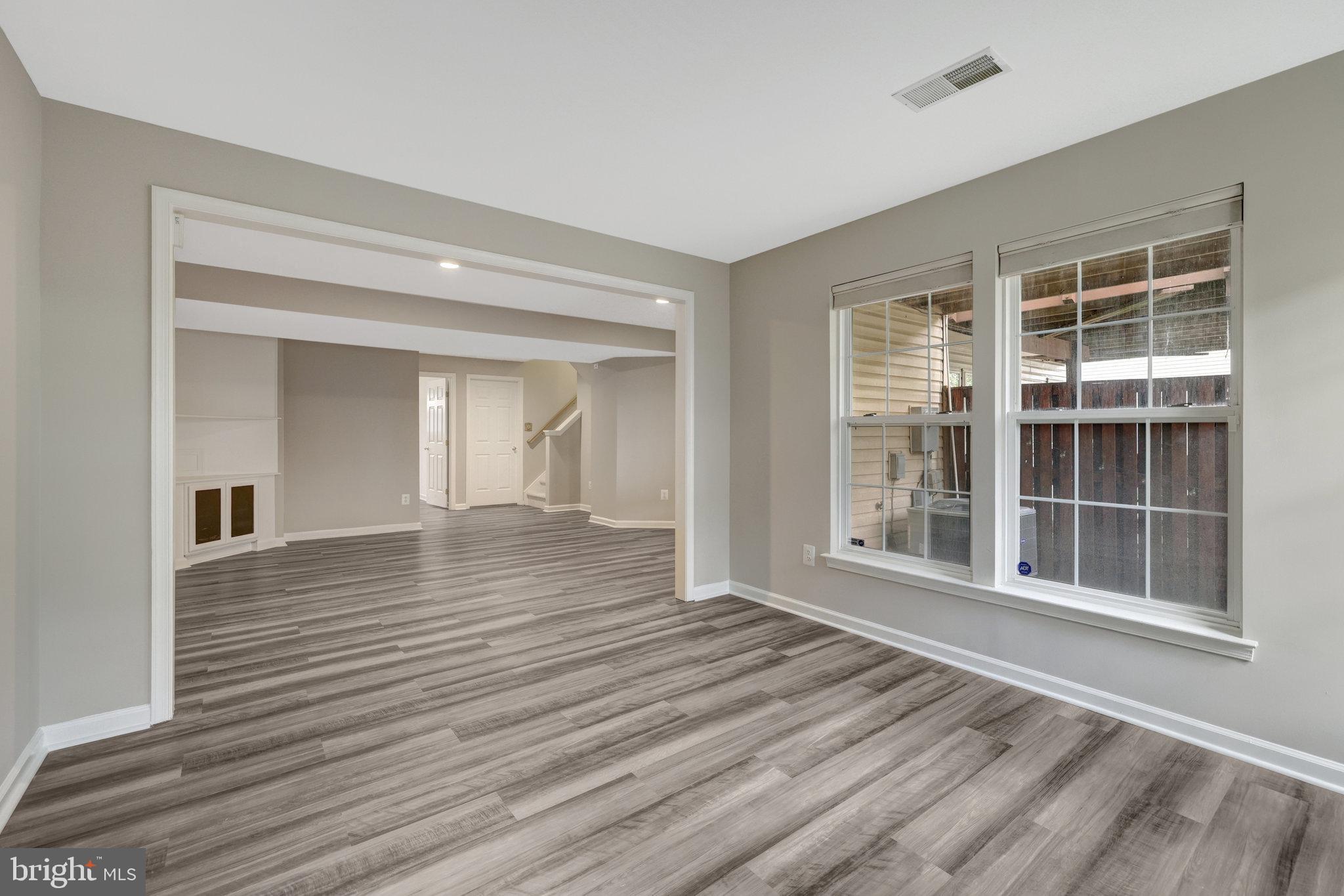43233 Stillforest Terrace Ashburn, VA 20147 - Photo 22 of 24 a view of empty room with wooden floor and windows