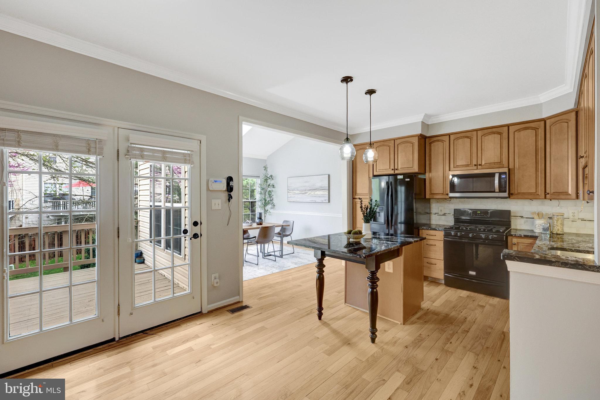 43233 Stillforest Terrace Ashburn, VA 20147 - Photo 5 of 24 a living room with stainless steel appliances kitchen island granite countertop furniture and a view of kitchen