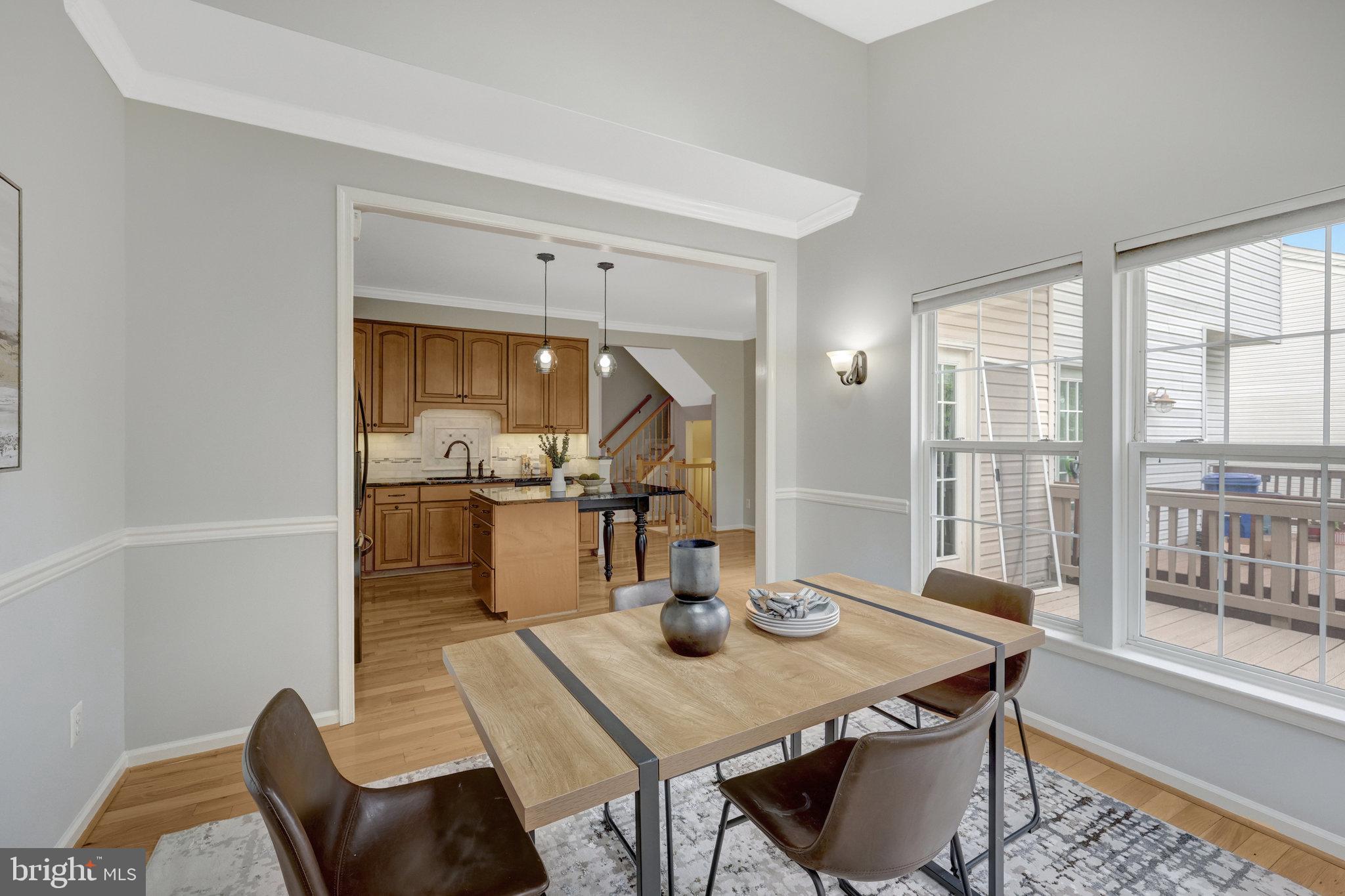 43233 Stillforest Terrace Ashburn, VA 20147 - Photo 10 of 24 a view of a dining room with furniture and wooden floor