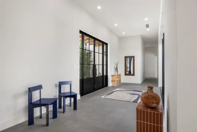 a view of a dining room with furniture and chandelier