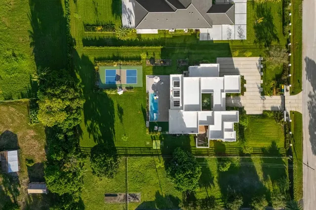 an aerial view of a house with swimming pool garden and patio