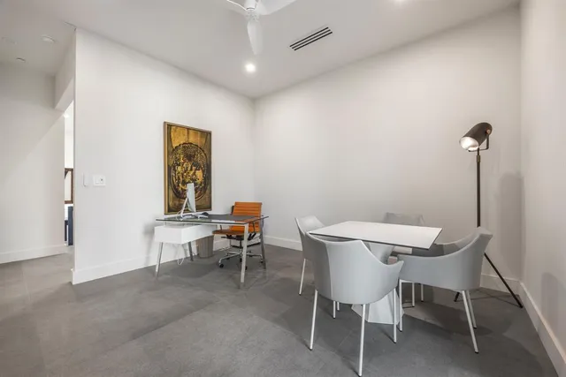 a bedroom with a bed television and a large window