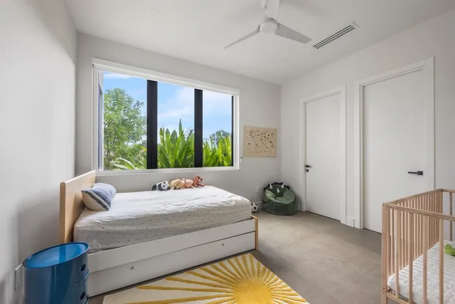 a bathroom with a toilet sink vanity and mirror