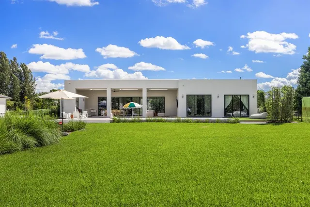 a view of a swimming pool with an outdoor seating and a garden