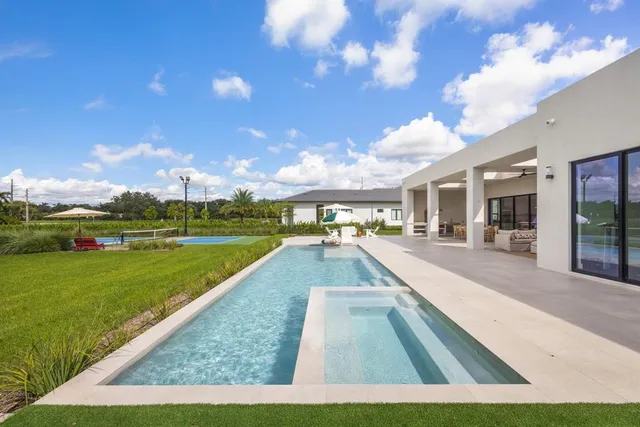 a view of swimming pool with outdoor seating
