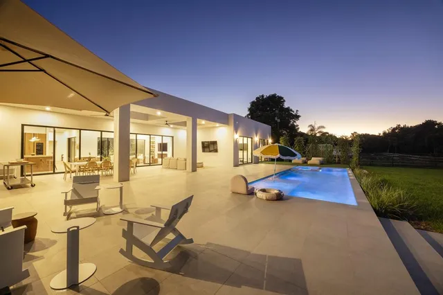 a front view of a house with a yard and trees