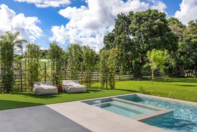 a living room with patio furniture and a large window