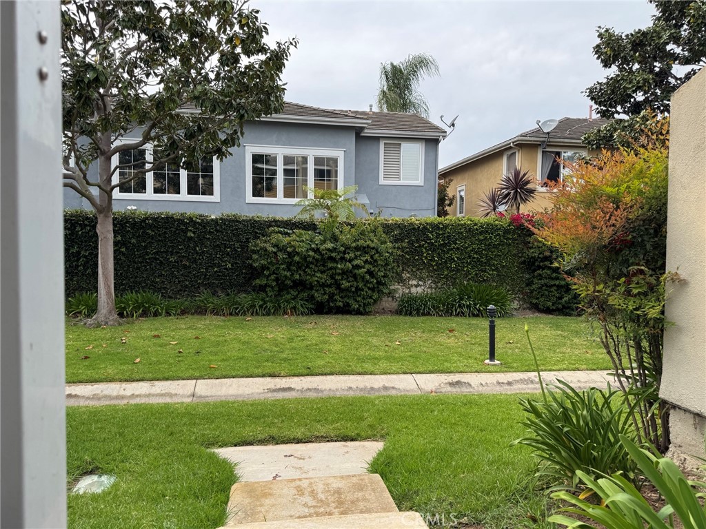 18697 Club Huntington Beach, CA 92648 - Photo 11 of 17 a front view of a house with a yard