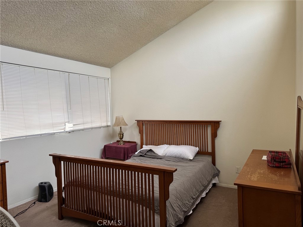 18697 Club Huntington Beach, CA 92648 - Photo 6 of 17 a bedroom with a bed and a window