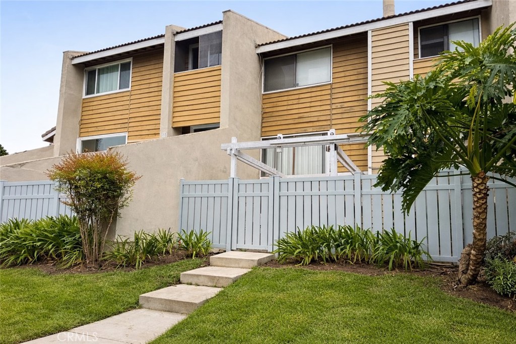 18697 Club Huntington Beach, CA 92648 - Photo 7 of 17 a view of a house with a yard and plants