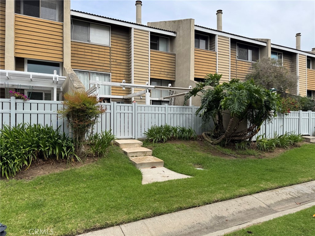 18697 Club Huntington Beach, CA 92648 - Photo 8 of 17 a front view of a house with garden