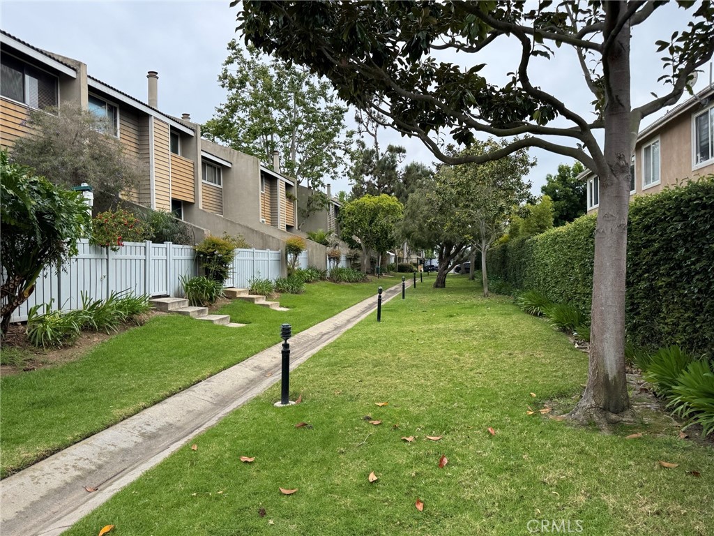 18697 Club Huntington Beach, CA 92648 - Photo 9 of 17 a view of a house with backyard and a tree
