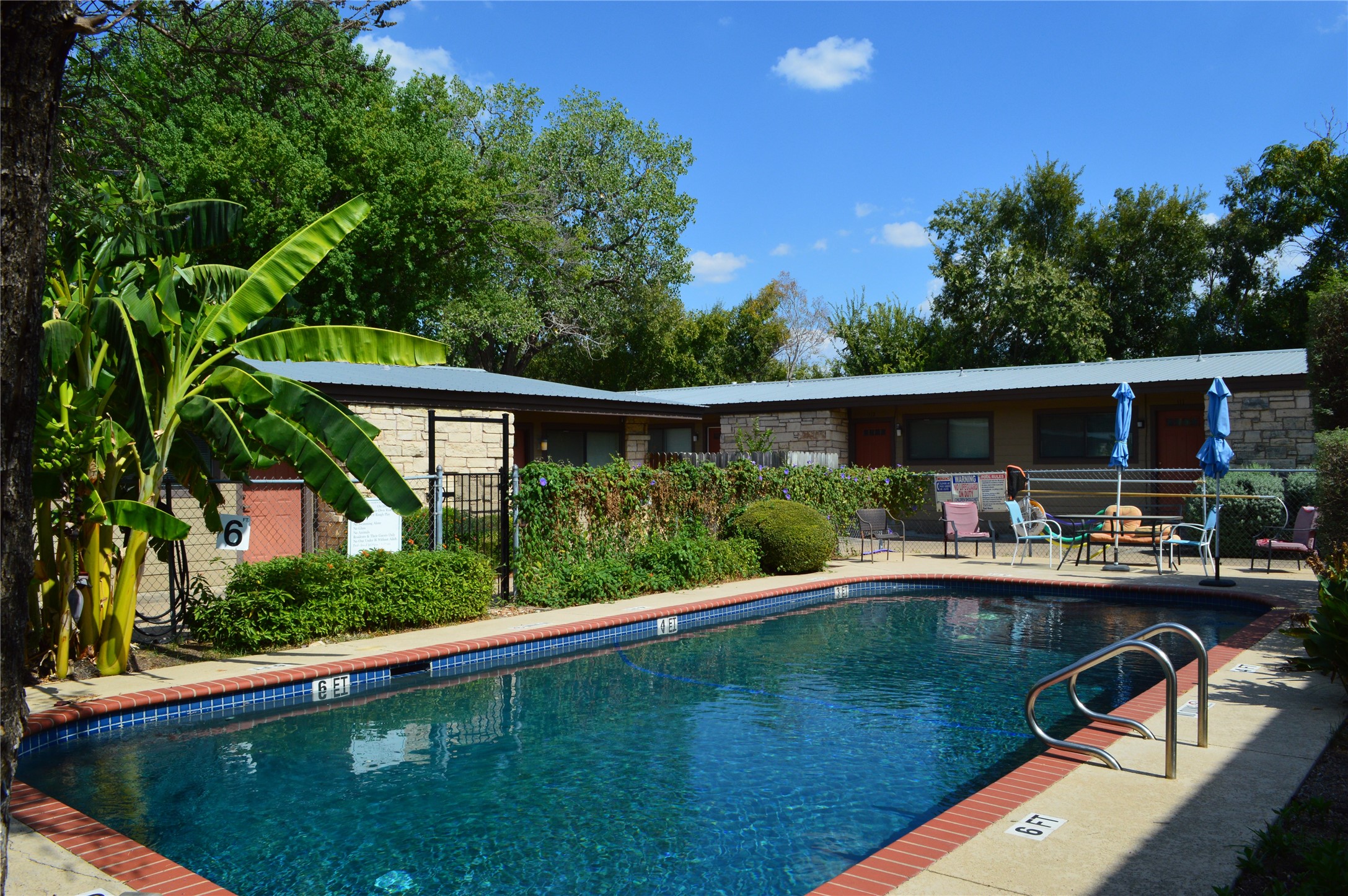 5001 Bull Creek Road, Unit 116 Austin, TX 78731 - Photo 3 of 6 a view of backyard with swimming pool and outdoor seating