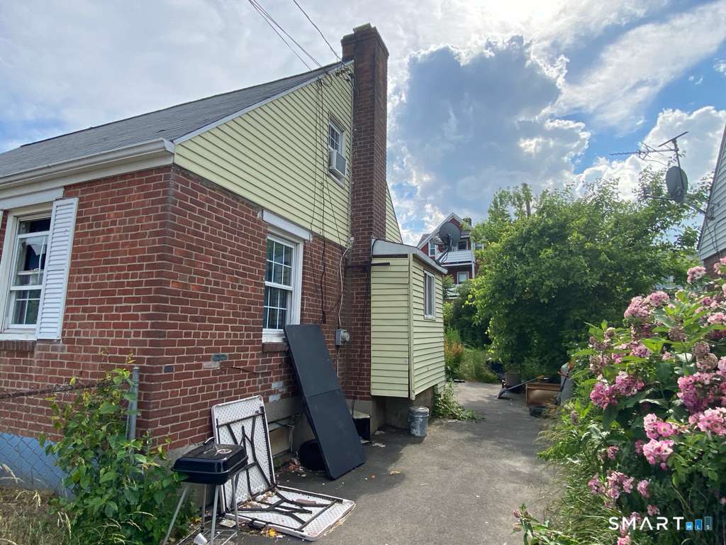 19 Baldwin Street Hartford, CT 06114 - Photo 4 of 4 a view of backyard with a chair and potted plants