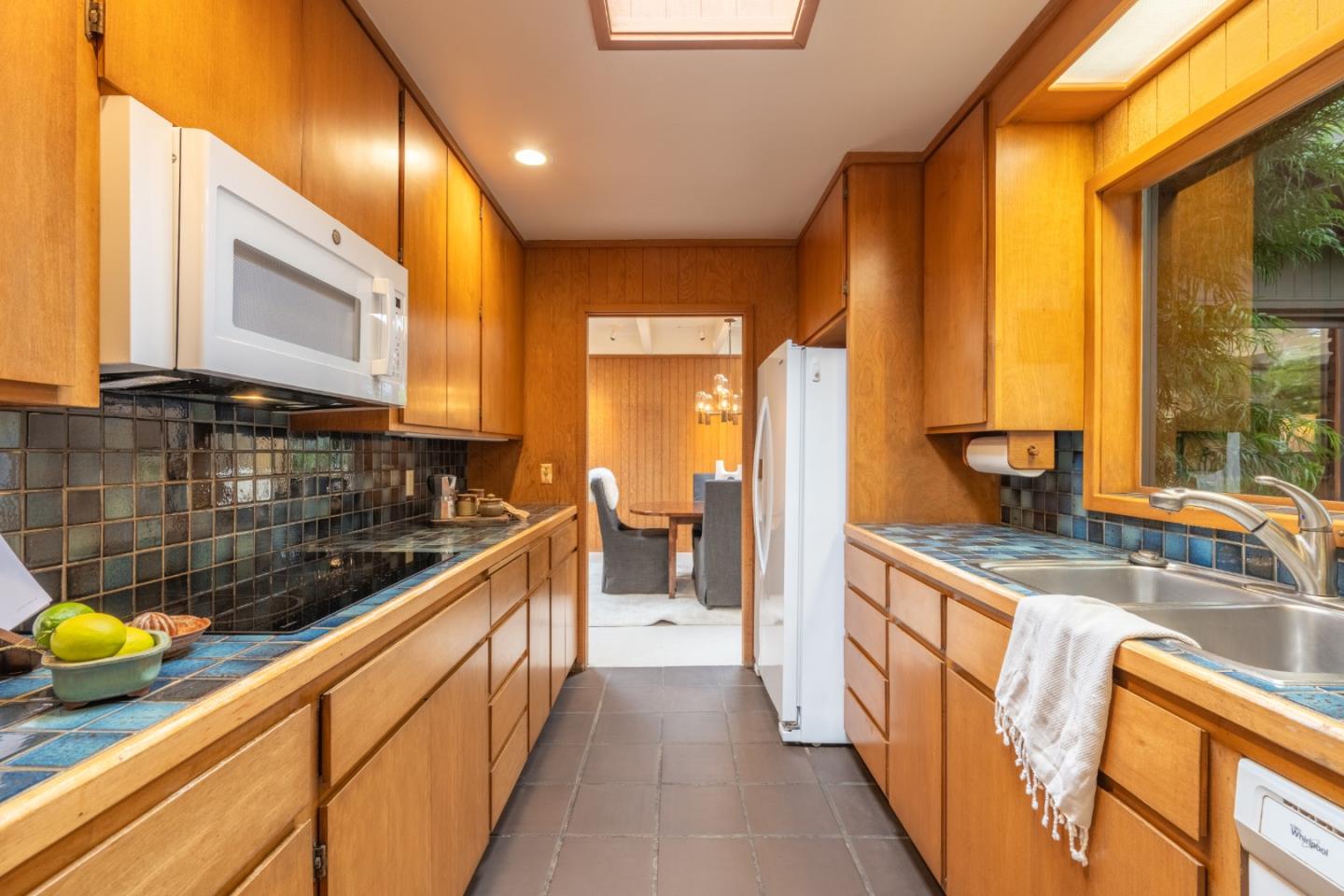 46 Middle Canyon Road Carmel Valley, CA 93924 - Photo 27 of 74 a kitchen with stainless steel appliances granite countertop a sink and a wooden cabinets