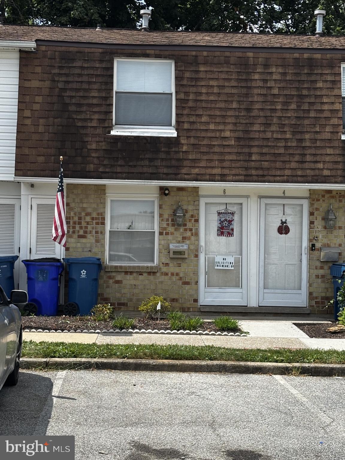 a view of a brick house with a small yard